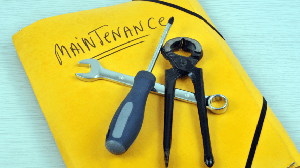 Tools placed on a yellow maintenance folder symbolizing repair and Facility Manager Services for efficient building care.